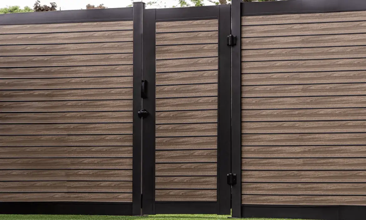 Aluminum fence gate installed alongside matching wood-grain privacy fence panels in a Canadian backyard