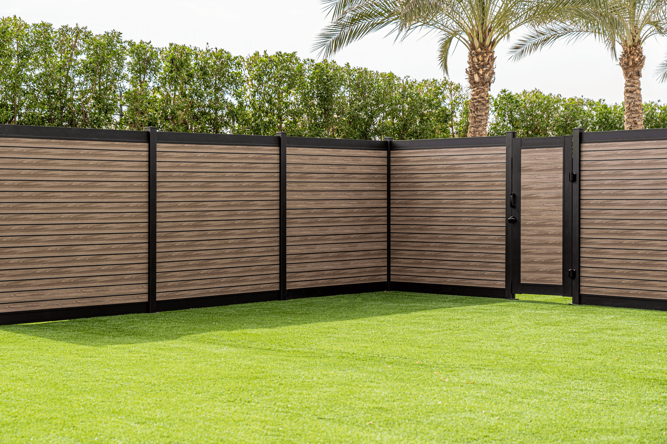 Grey wood-grain aluminum fence in a Canadian backyard
